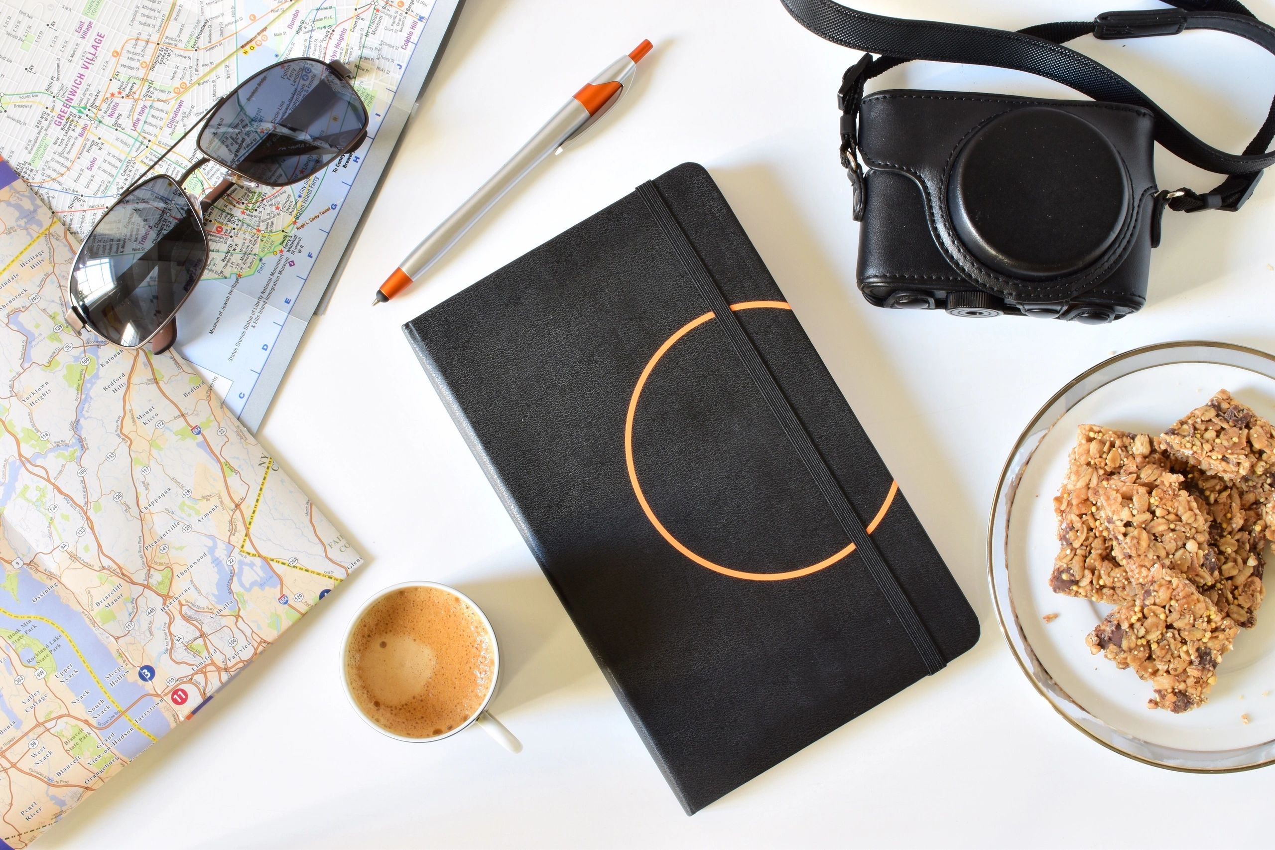 Travel planning notes and essentials on a table